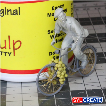 A scale model of a French man on a bicycle sculpted using Magic Sculp Epoxy Modelling Putty