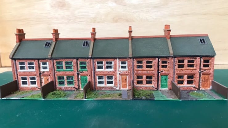 A model rail layout created by taking silicone moulds of customised sets built with plasticard which are then cast in resin
